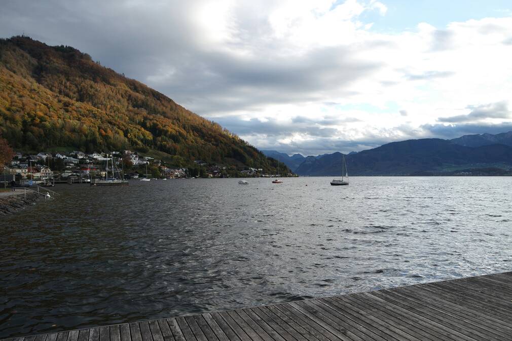 The sun-drenched Esplanade lakefront promenade in Gmunden Austria with views of Lake Traunsee.