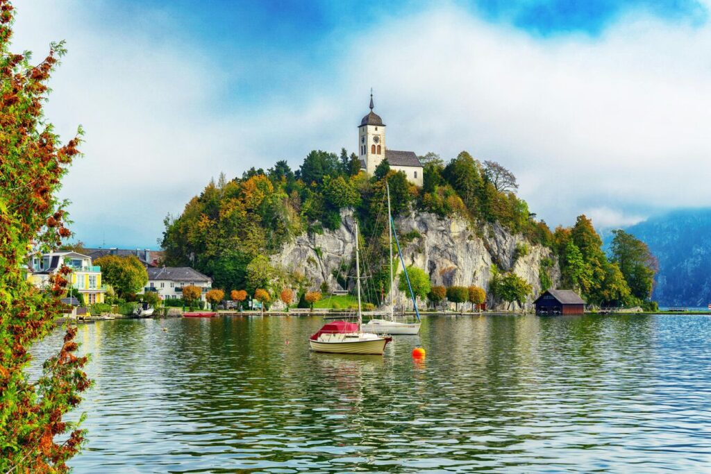 A wide, bright panoramic shot of the Gmunden lakefront in Gmunden, Austria.