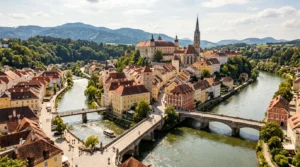 Aerial view of the confluence of the Enns and Steyr rivers in the heart of Steyr, showcasing the medieval architecture and riverside paths.